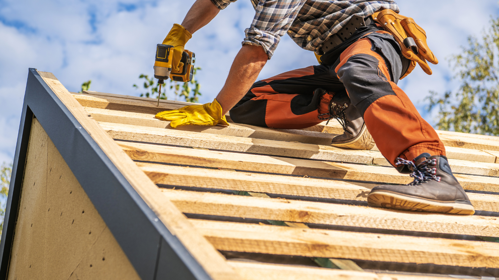 A man working on the roof of a house