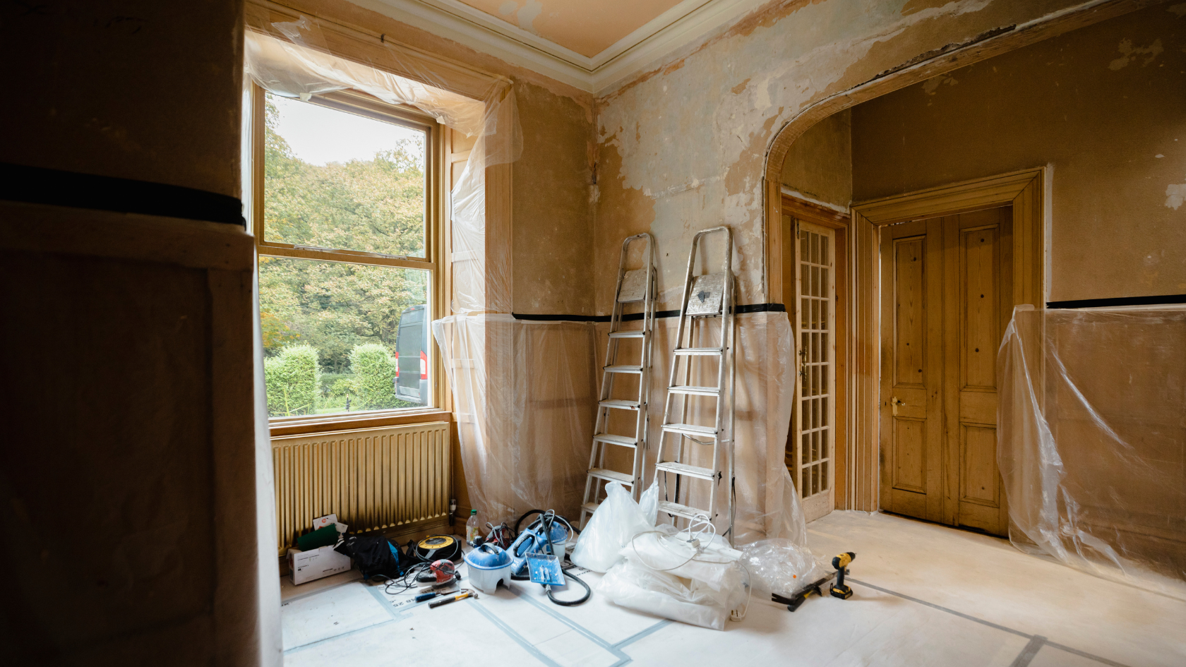 A room with a ladder and a window in it