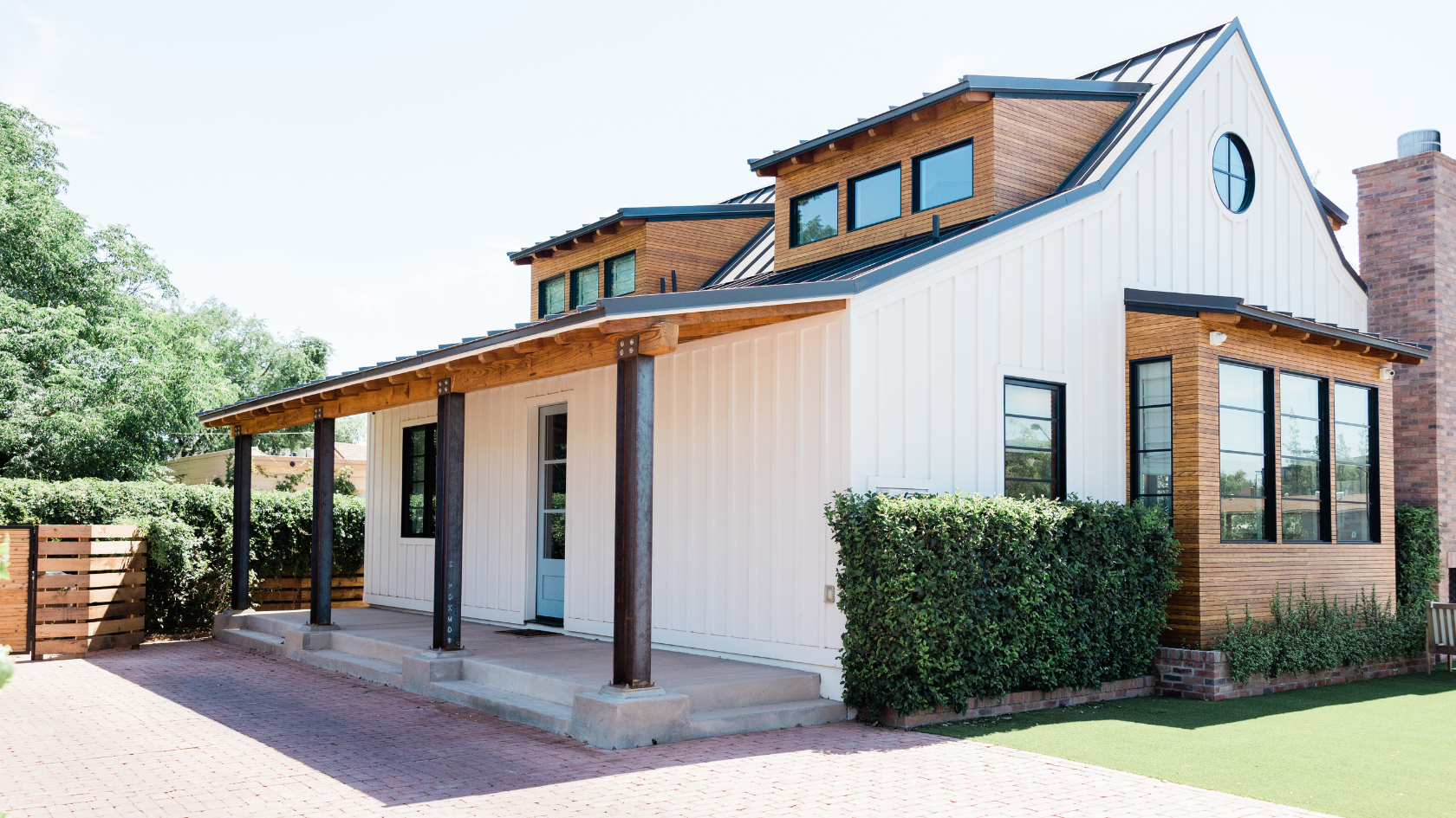 A white house with a black roof and windows