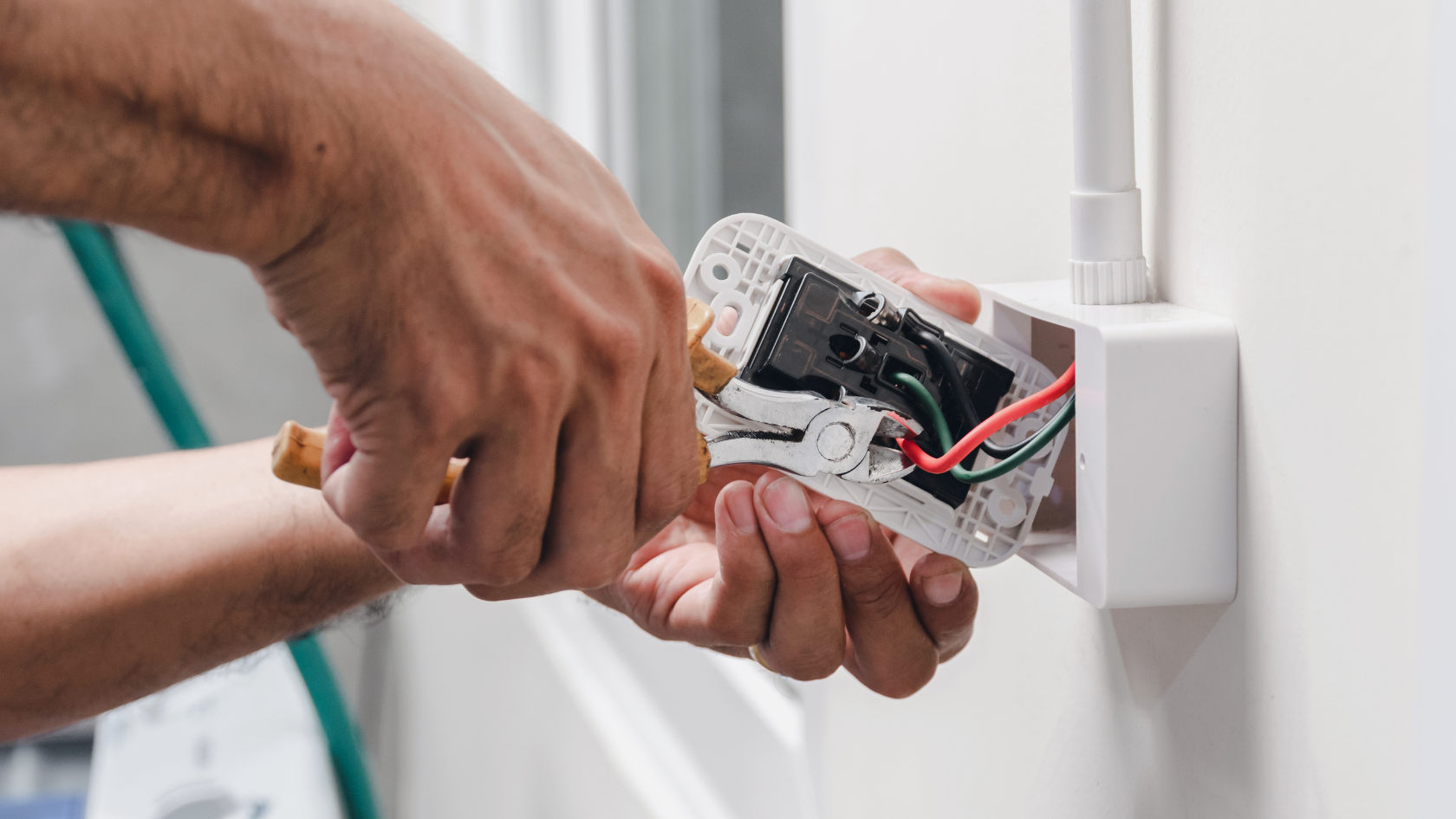 A man is holding an electrical device in his hand