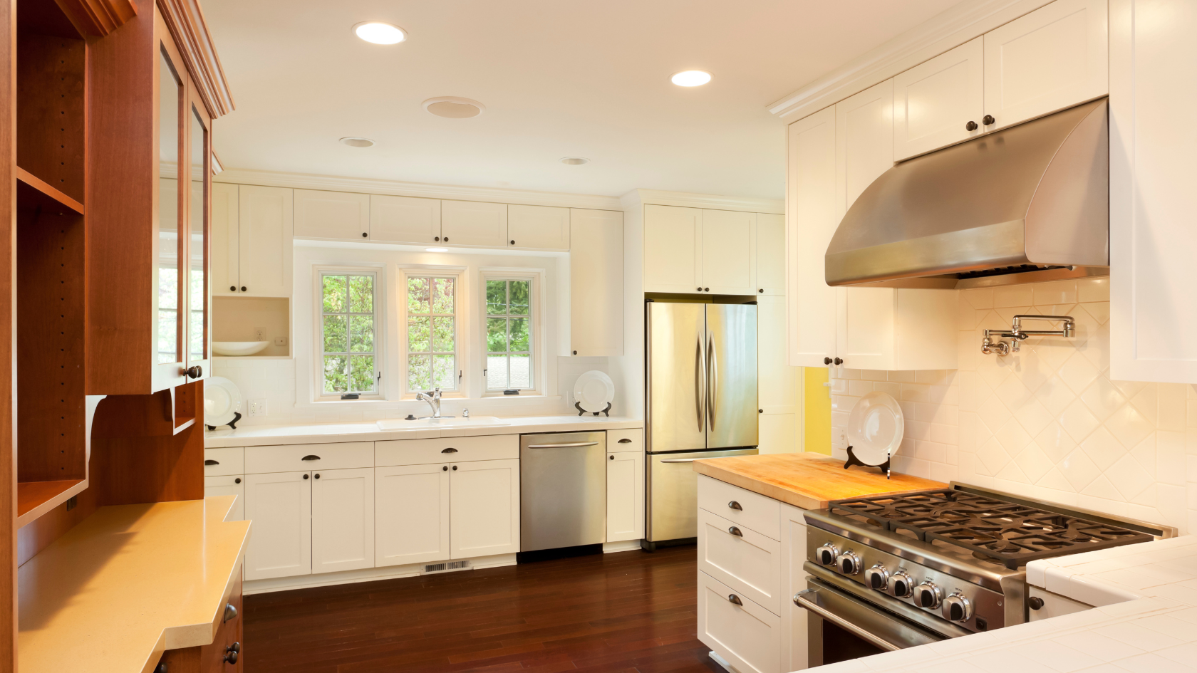 A kitchen with a stove top oven next to a sink